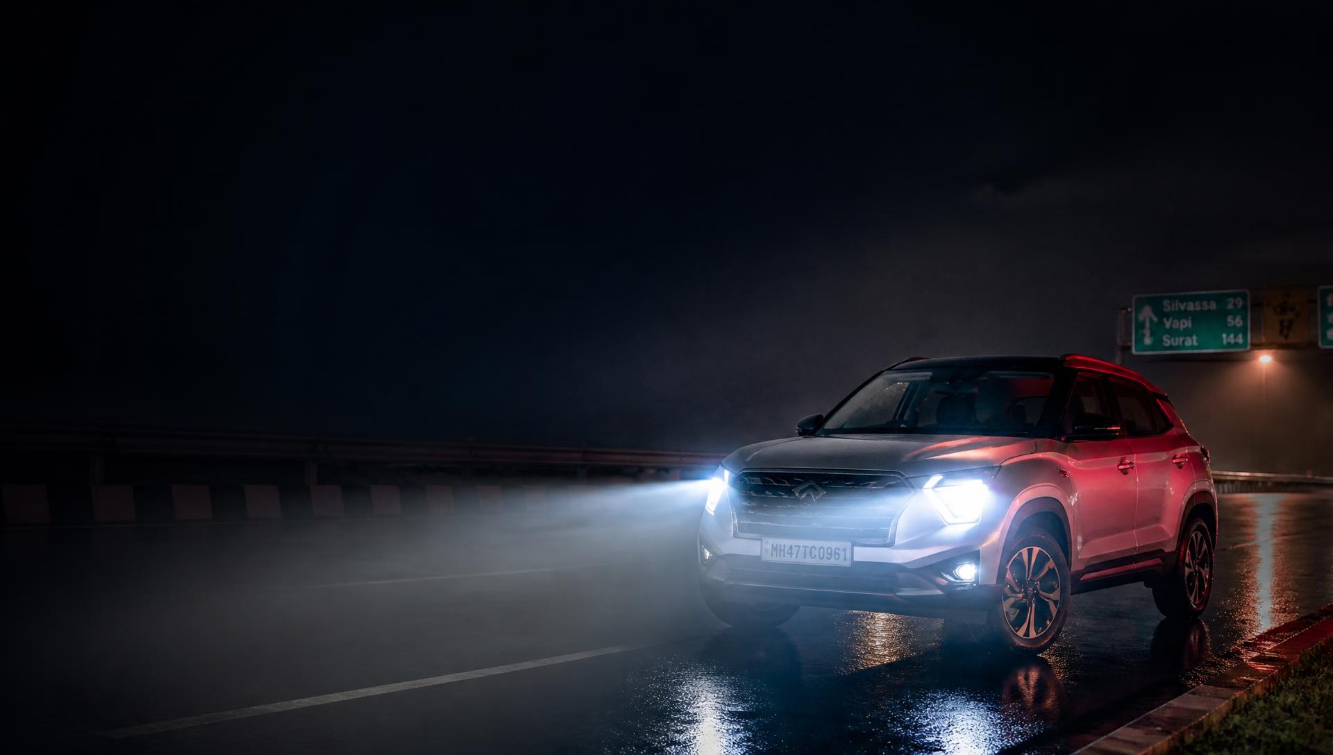 Car with upgraded LED headlights driving on a wet highway at night